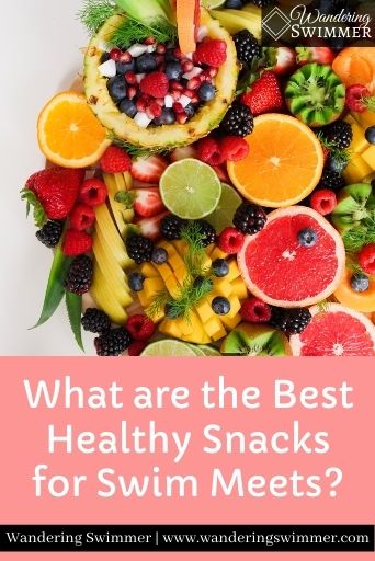 Image with a picture of assorted fruits in the top 3/4 of the image. Light pink fills the bottom 1/4 with text that reads: What are the Best Healthy Snacks for Swim Meets?