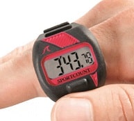 Image of a finger wearing a red  SportCount Chrono 200 Lap Counter, which can be used to count laps in swimming